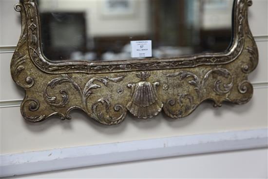 A George II style carved silvered wood framed wall mirror, Height 3ft 1in. Width 1ft 8in. H.3ft 1in.